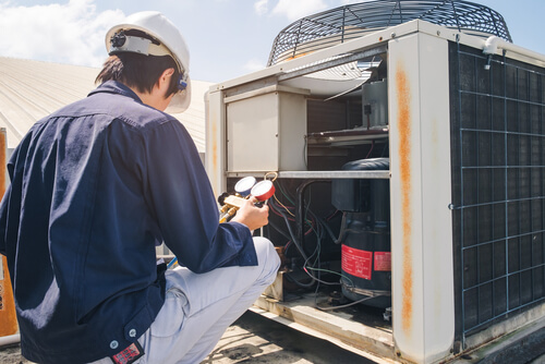 Picture of service technician performing an AC Tune Up on an HVAC System