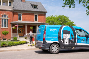 Jolly Plumbing van outside a home