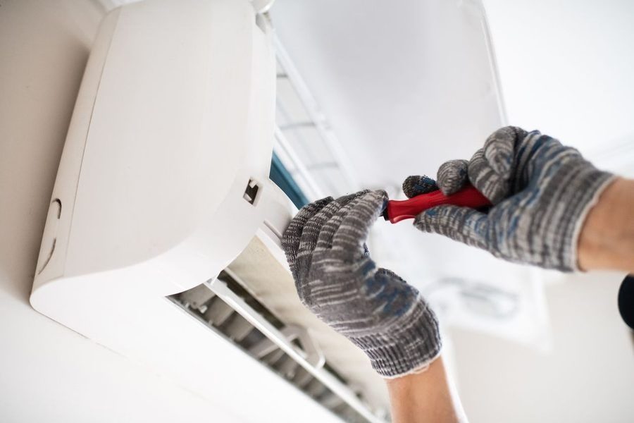 Professional installing a ductless mini-split inside a home.
