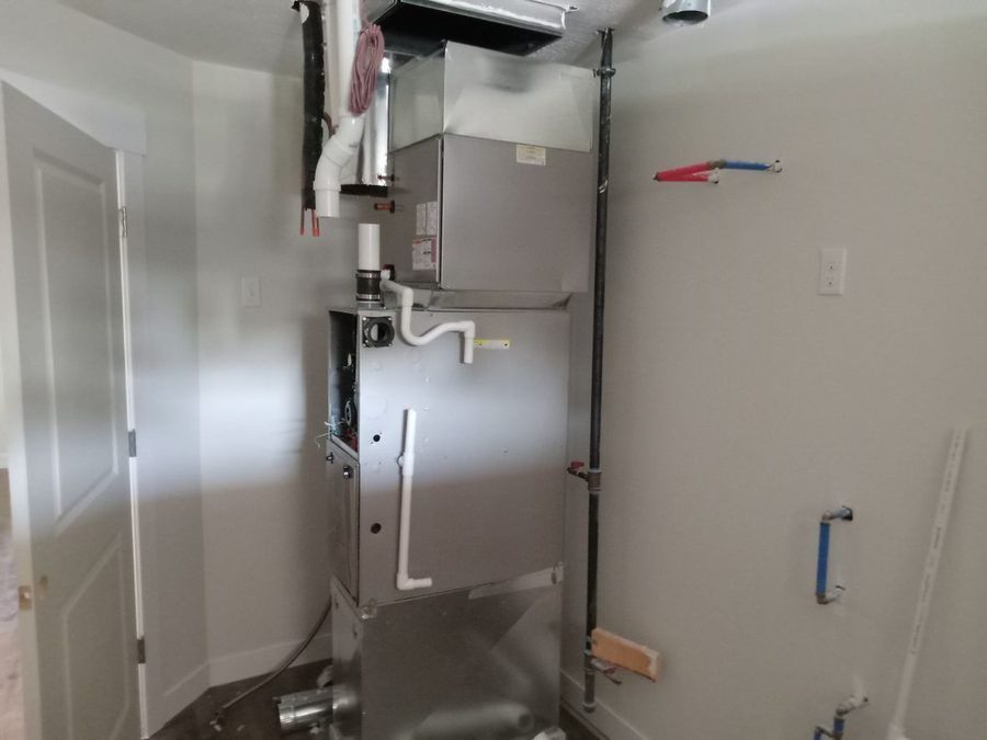 New furnace system being installed inside home closet.