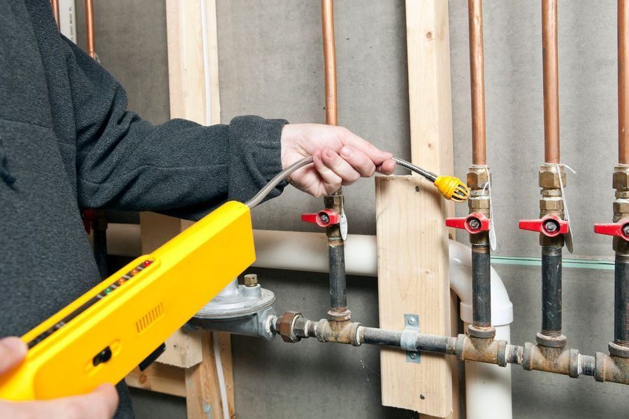 Technician using professional tools to check on the gas line.
