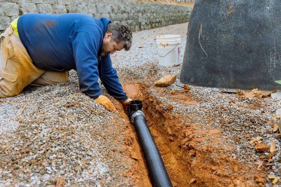 Professional installing a new sewer line.