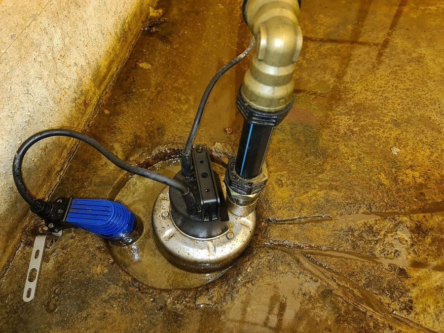 Newly installed sump pump, removing water from a basement.