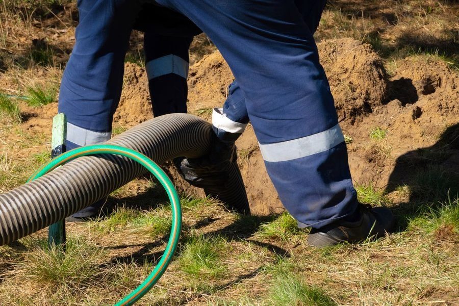 Professional plumber using underground plumbing repairs without yard damage.