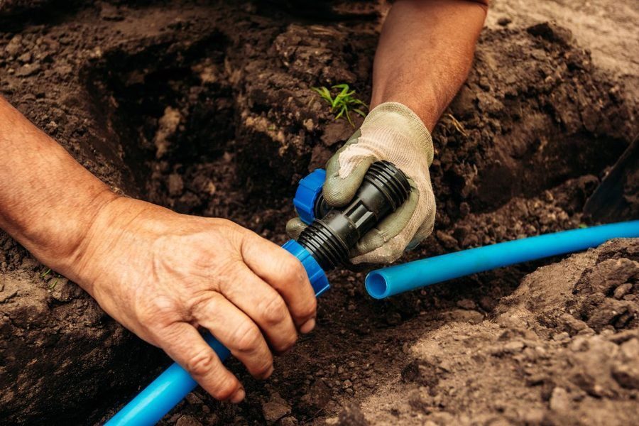 Plumber working on water line during install.