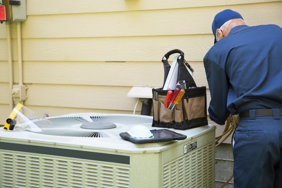 Technician inspecting an AC unit.