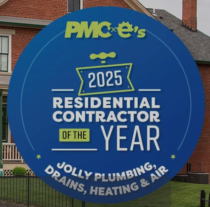 Blue circular yard sign announcing '2025 Residential Contractor of the Year' for Jolly Plumbing, Drains, Heating & Air in a front yard.